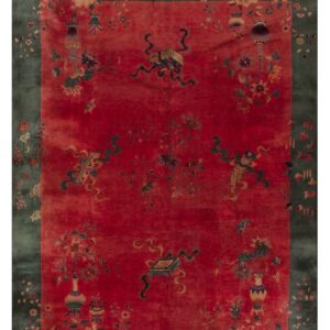 Ornate crimson rug with scattered vases and scrolls, featuring a wide teal-green floral border.