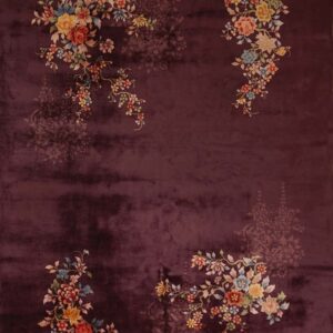 Deep purple rug with lustrous pile, featuring colorful corner florals and faded tone-on-tone center motifs.