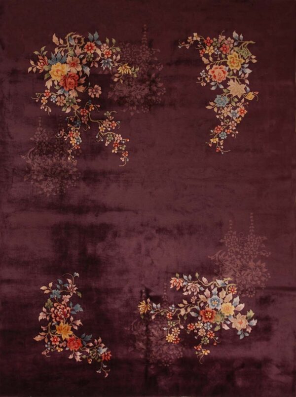 Deep purple rug with lustrous pile, featuring colorful corner florals and faded tone-on-tone center motifs.