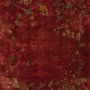 Deep red rug featuring trailing vines, gold flowers, and a green key pattern border.