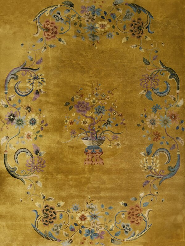 Gold rug with a plush texture and detailed floral medallion framed by an oval scrolling border.