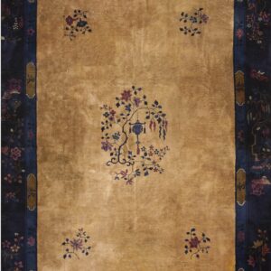 Tan rug with a high sheen, contrasted by a dark blue border filled with detailed multicolored florals.