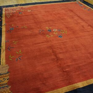 Red field rug with navy border and gold guard stripe featuring colorful vines and stylized blossoms.