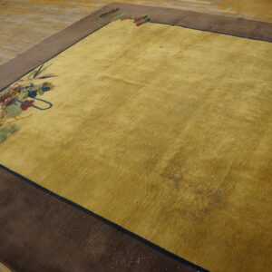 Low-pile golden yellow rug featuring corner floral details and a broad solid brown outer border on wood flooring.