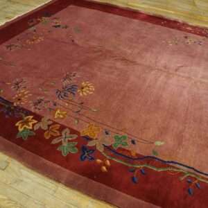 High-pile mauve and burgundy rug with colorful stylized floral patterns on light wood flooring.