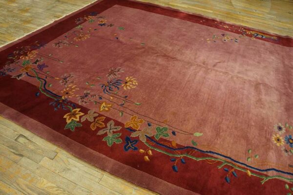 High-pile mauve and burgundy rug with colorful stylized floral patterns on light wood flooring.