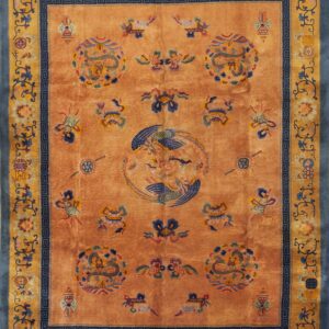 Apricot rug with a high sheen, featuring blue dragons, a central bird, and blue and gold floral borders.