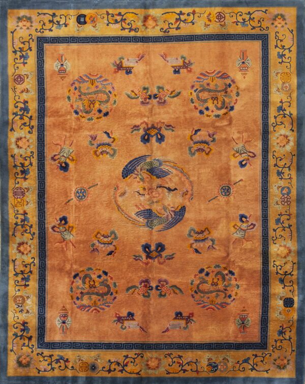 Apricot rug with a high sheen, featuring blue dragons, a central bird, and blue and gold floral borders.