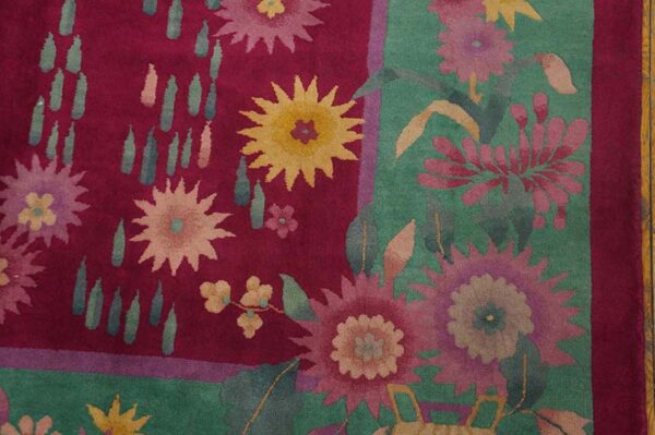 High-pile rug detail showing magenta and teal floral patterns next to hardwood flooring.