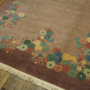 Mauve rug with scattered large circular flowers in blue, yellow, green, and rust on wood flooring.