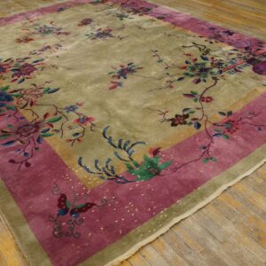 Chartreuse and magenta rug with a detailed multicolored floral and butterfly pattern on weathered wooden planks.