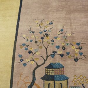 Lilac rug featuring a stylized tree and blue pagoda on a gold border near distressed wood flooring.