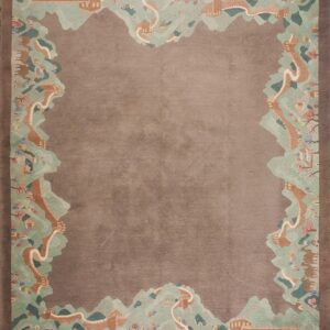 Brown rug with a detailed pictorial border of green mountains, terracotta walls, figures, and camels.