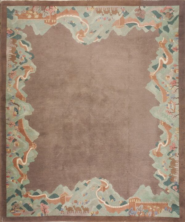 Brown rug with a detailed pictorial border of green mountains, terracotta walls, figures, and camels.
