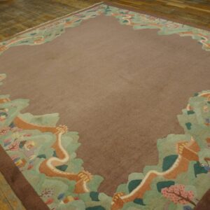Low-pile brown rug featuring a pictorial green and orange border with camels and trees on wood planks.