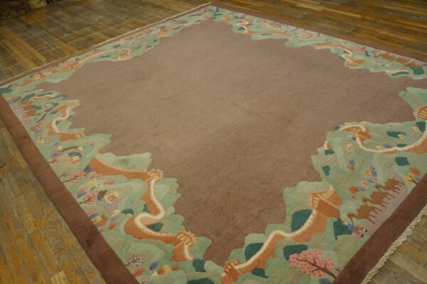 Low-pile brown rug featuring a pictorial green and orange border with camels and trees on wood planks.
