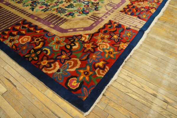 Multicolor stylized floral rug with red and beige fields and geometric borders on light wood flooring.
