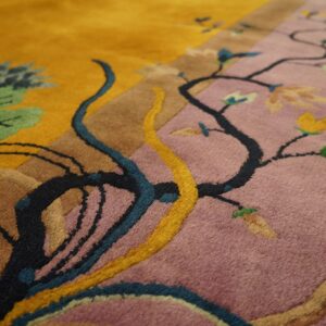 A plush rug close-up shows floral vines traversing color blocks of gold, dusty purple, and brown.