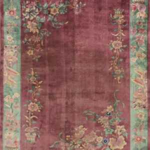 Deep rose rug with a wide celadon border featuring intricate flowering vines and classical motifs.