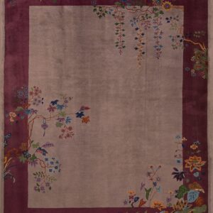 Taupe rug with a deep burgundy border and an elaborate design of colorful flowering branches and plants.