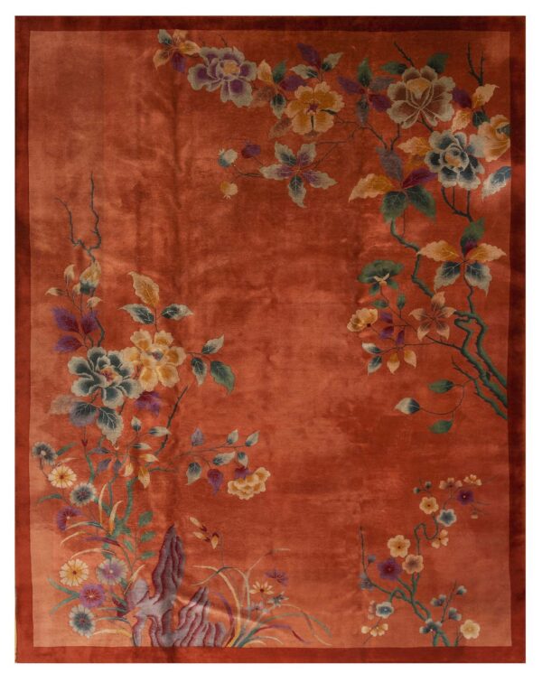 Terracotta rug with a visible sheen and wide border, displaying stylized multi-color floral branches.