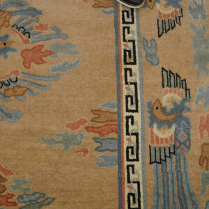 Decorative beige rug with intricate patterns.