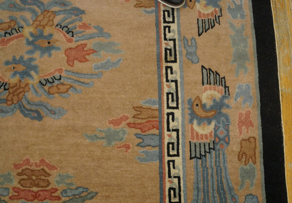 Decorative beige rug with intricate patterns.