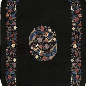 Oblong black rug with a central medallion and colorful floral and bird borders.