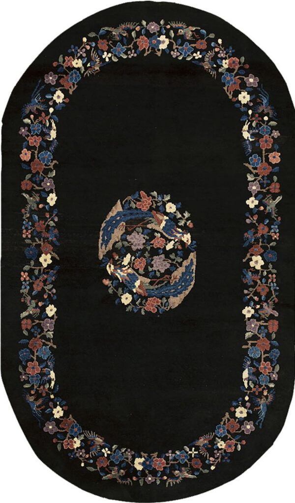 Oblong black rug with a central medallion and colorful floral and bird borders.
