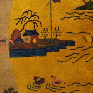 Mustard yellow rug with a scenic landscape design, detailed with blue waves, houses, and a tan border.