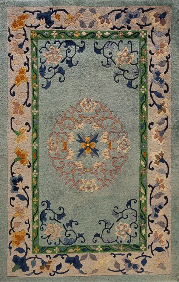 Light blue-green rug with an elaborate central medallion and borders featuring multicolored floral and vine motifs.
