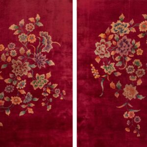 Plush burgundy rug with detailed floral sprays featuring gold, green, peach, and purple motifs.