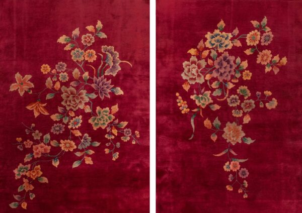 Plush burgundy rug with detailed floral sprays featuring gold, green, peach, and purple motifs.