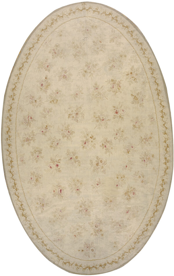 Oval cream rug with a scattered pattern of pale pink and tan roses and a light floral border.