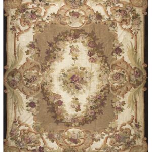 Low-pile rug with elaborate scrolling floral design in muted pink, green, cream, and brown tones.