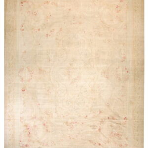 Soft cream area rug featuring delicate pink roses and scrolling rococo designs within a vine border.