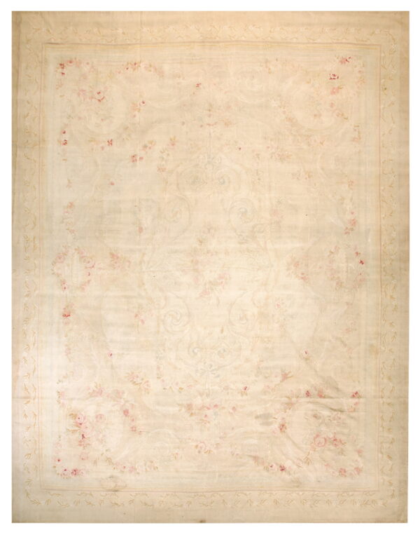 Soft cream area rug featuring delicate pink roses and scrolling rococo designs within a vine border.