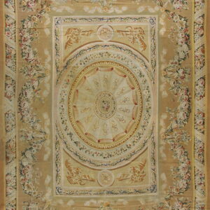 Elaborate low-pile rug with a gold background, cream medallion, and borders of pink and white florals.