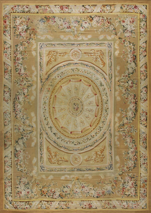 Elaborate low-pile rug with a gold background, cream medallion, and borders of pink and white florals.