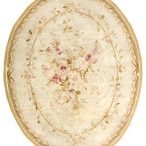 Round cream rug featuring a pink and tan floral bouquet medallion surrounded by a tan leaf garland border.