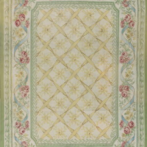 Cream and pale green rug with pink roses, blue ribbons, and a central yellow lattice pattern.