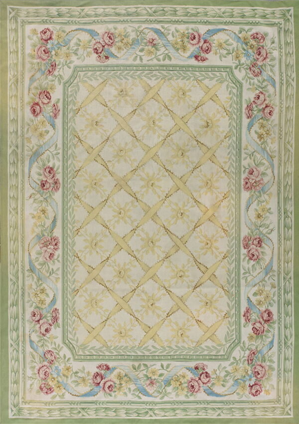 Cream and pale green rug with pink roses, blue ribbons, and a central yellow lattice pattern.
