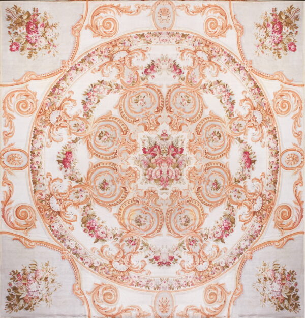 Symmetrical white rug featuring an ornate central medallion framed by peach scrolls and pink florals.