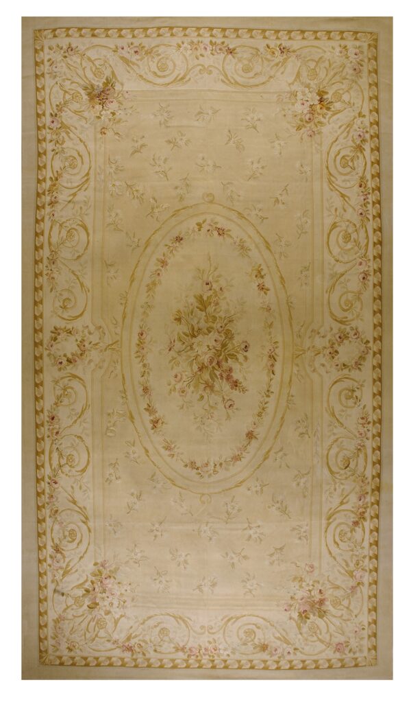 Pale beige rug featuring intricate floral bouquets and gold scrolling borders surrounding a central medallion.