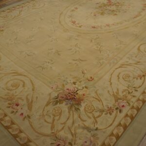 Cream and pale sage floral rug featuring pink roses and gold scrollwork on wood plank flooring.