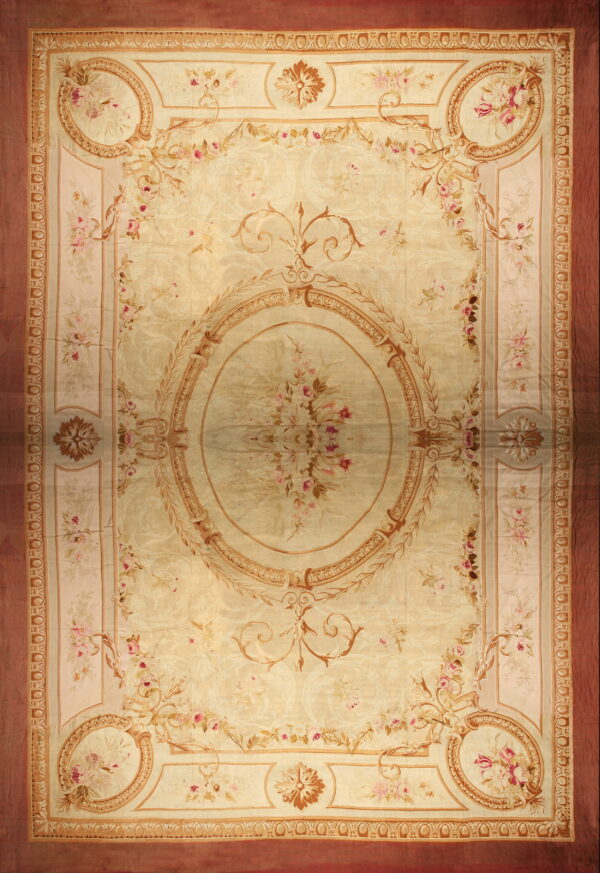 Ornate pale beige rug featuring a large floral medallion, scrolling vines, and a solid reddish outer border.