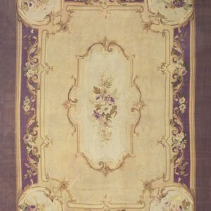 Ornate cream rug with purple borders and scrolling gold framework surrounding floral bouquets.