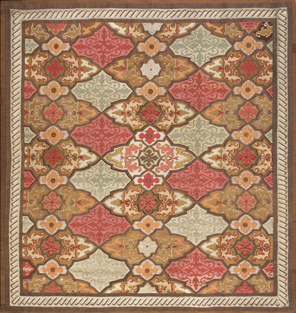 Square rug with a geometric tile pattern in coral, brown, orange, sage, and cream colors.