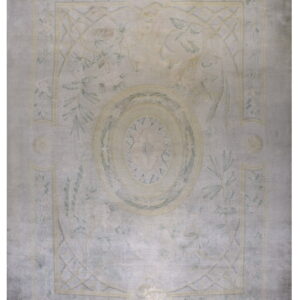 Washed gray area rug with a pale yellow traditional border and muted green botanical designs.