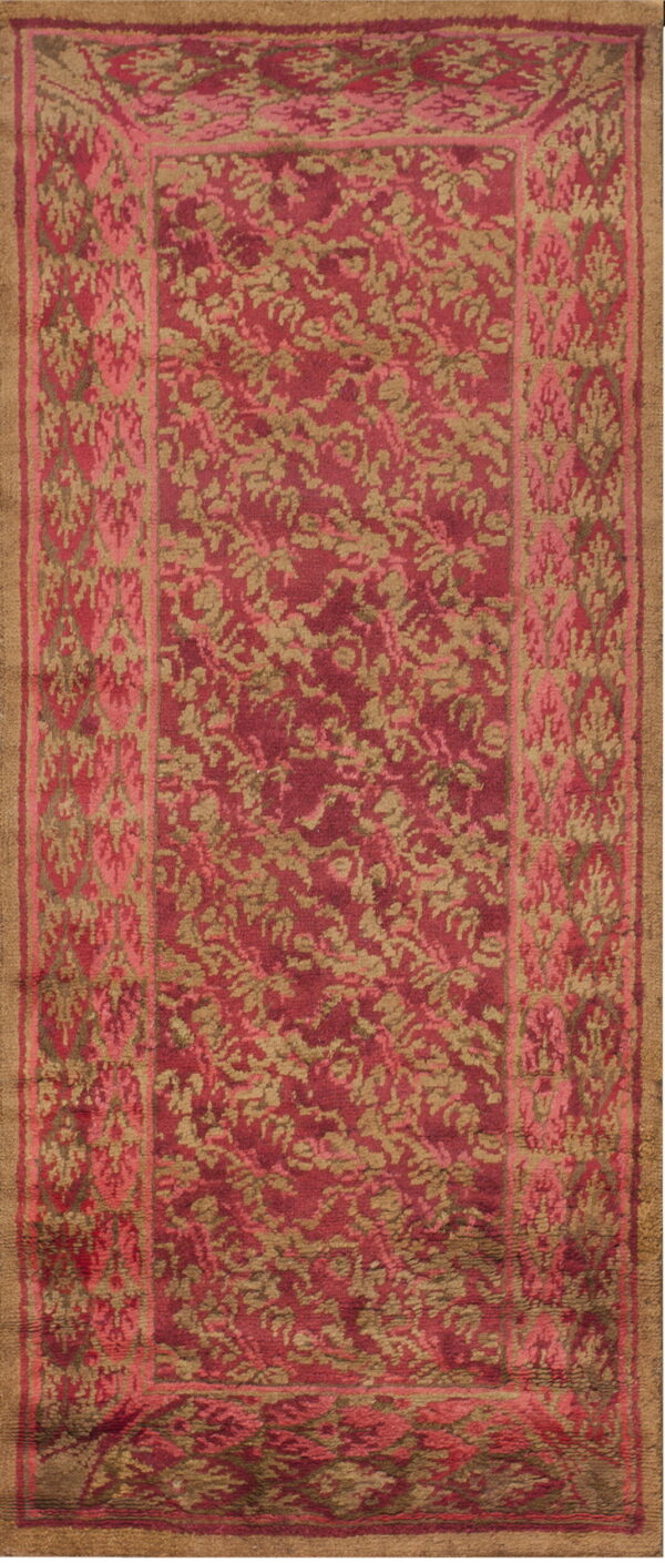High-pile runner rug with tan floral motifs on maroon, featuring a detailed patterned pink and tan border.